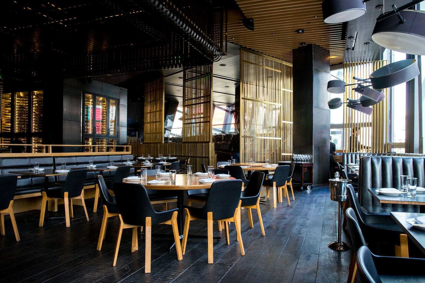 Warm restaurant dining room in the evening, tables set